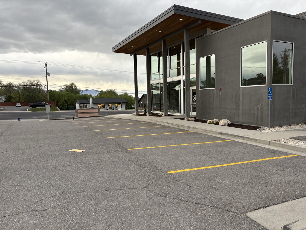 Yellow parking stalls along a modern office building