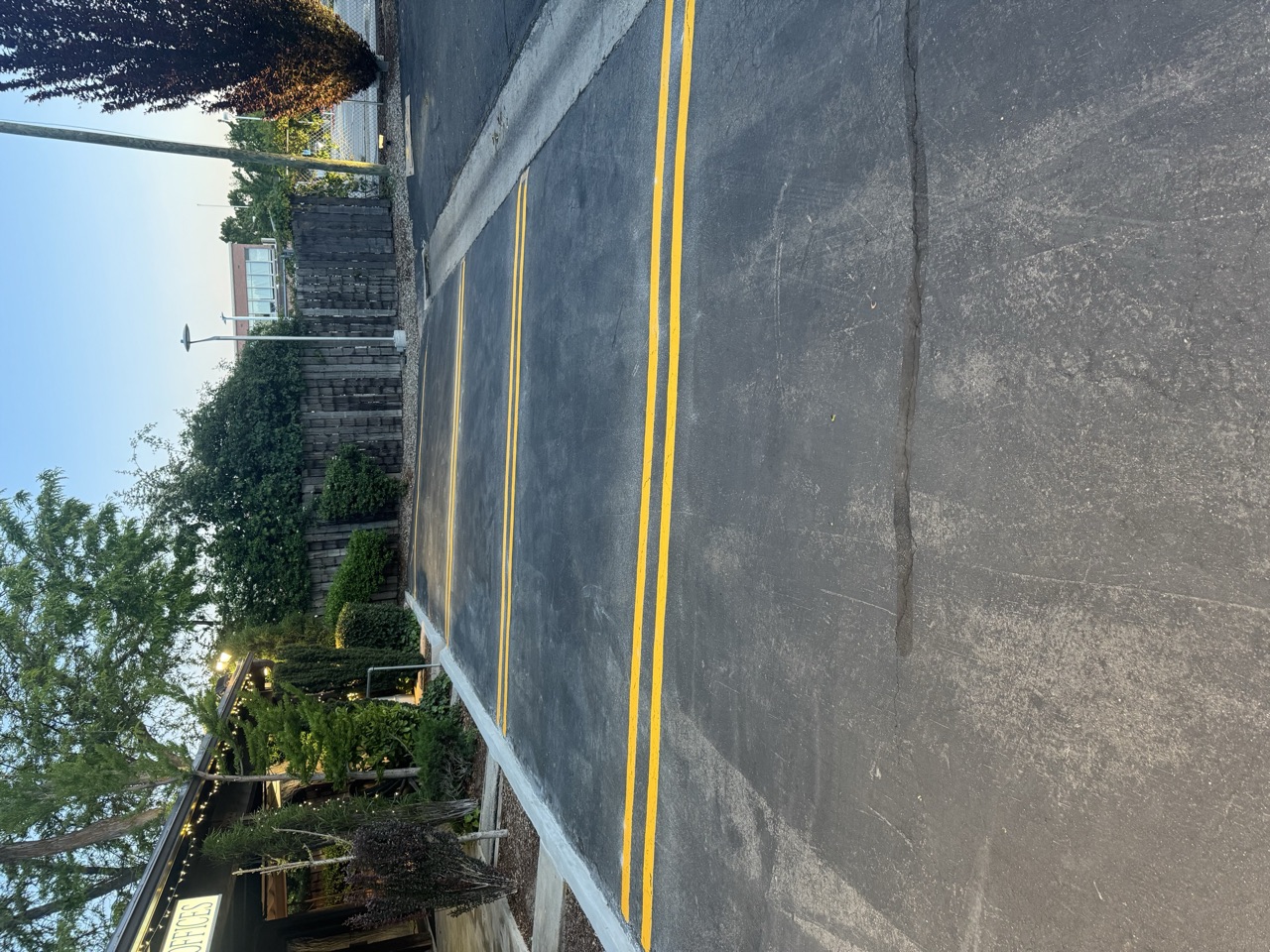 Yellow double lines across a commercial drive aisle