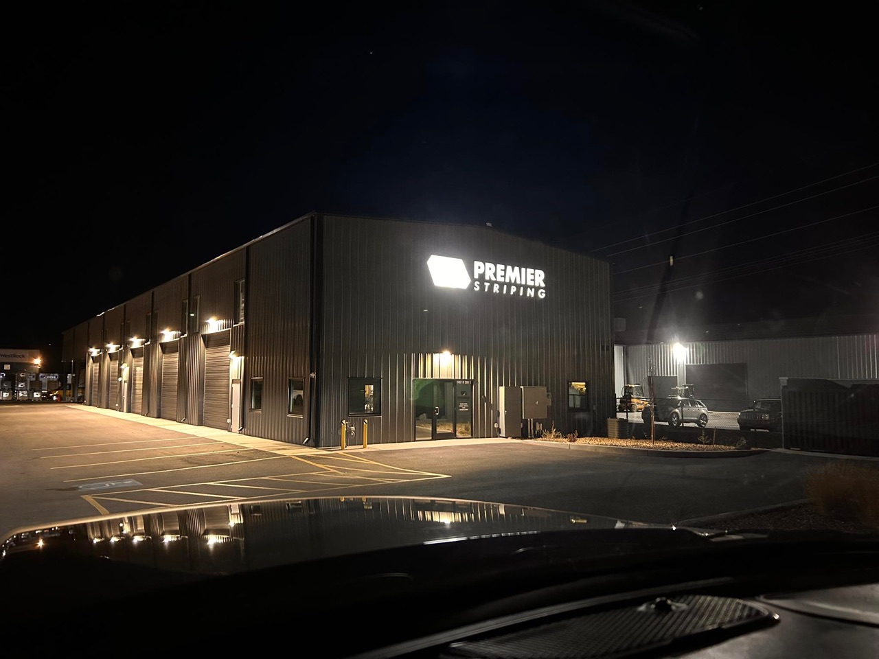 Premier Striping facility and striped parking lot at night