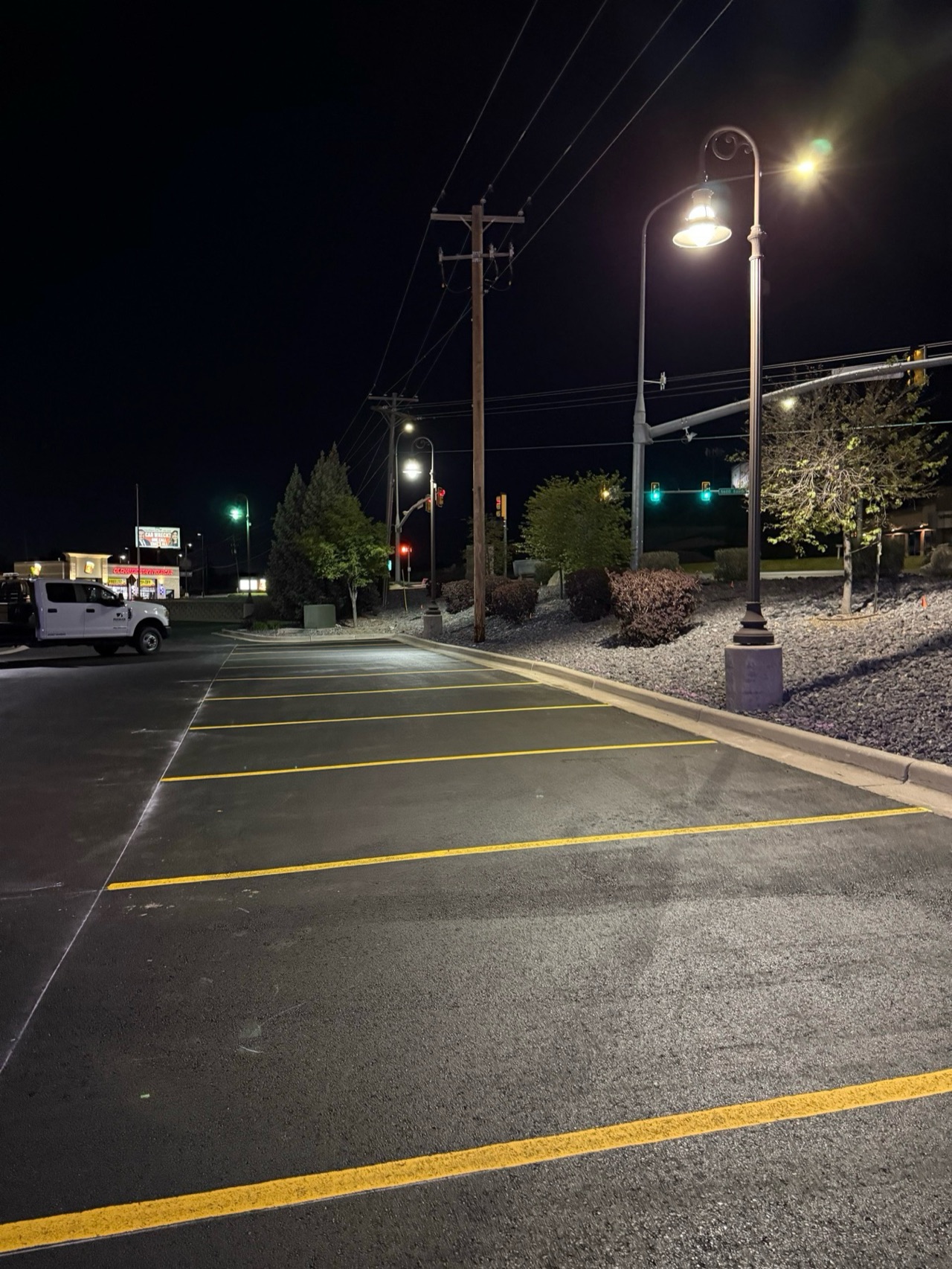 Fresh yellow parking stalls in a commercial lot at night