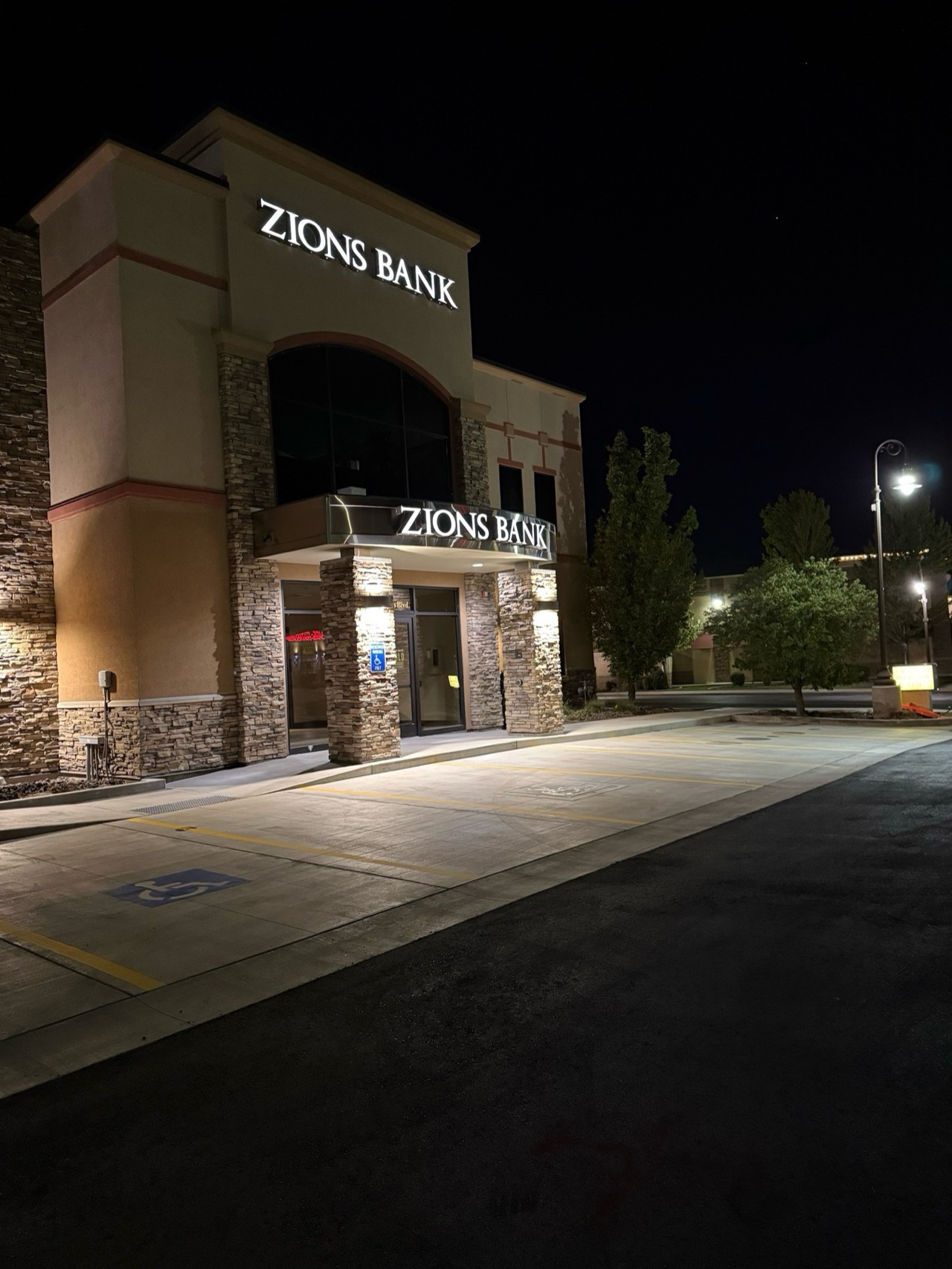 Premier Striping parking area outside a bank at night